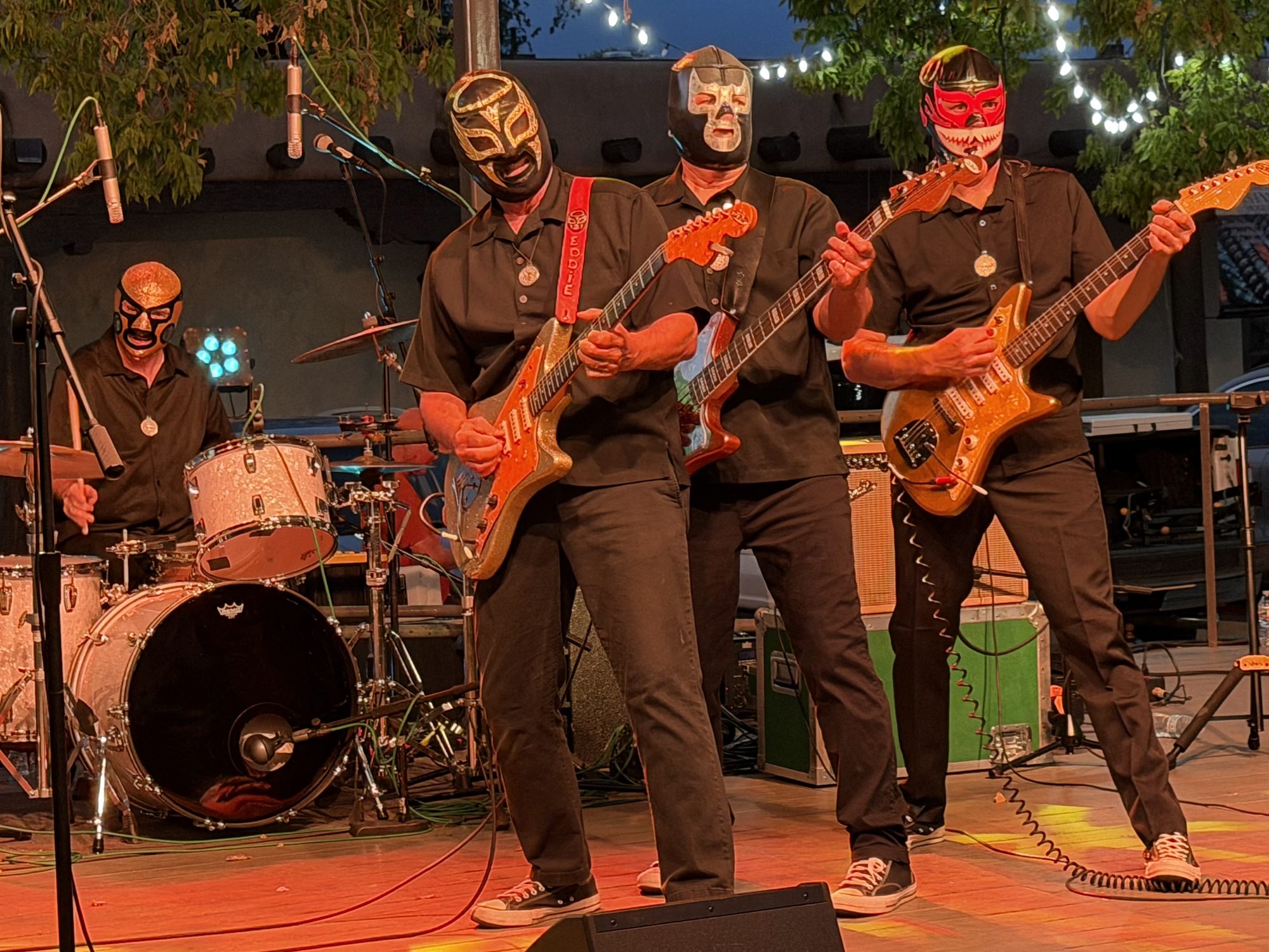 A masked rockabilly band performing in Santa Fe Plaza