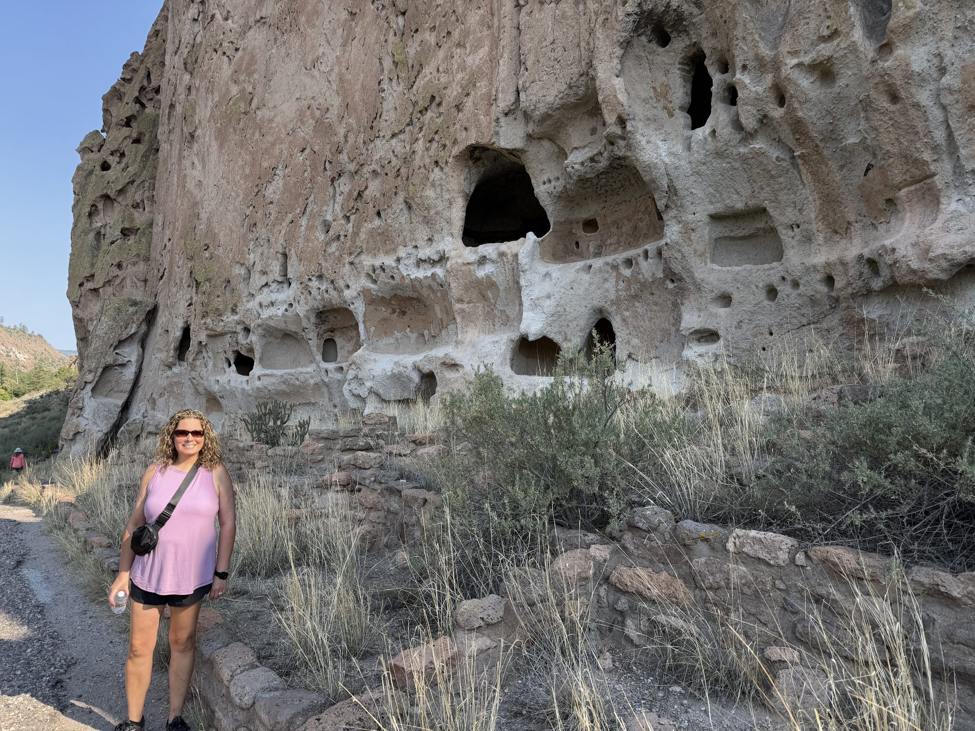 Linda beside the cliff dwellings at Bandelier National Monument